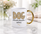 White mug with gold handle featuring 'DOG mama SOPHIE' text on a marble surface.