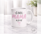 White mug with 'Girl Mama Katie' text on a marble surface