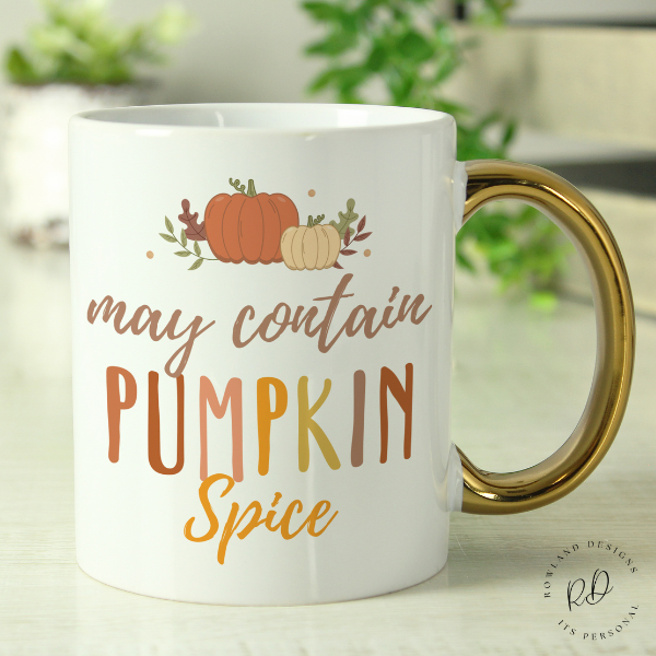 Close-up of gold handle on personalised pumpkin spice coffee mug halloween