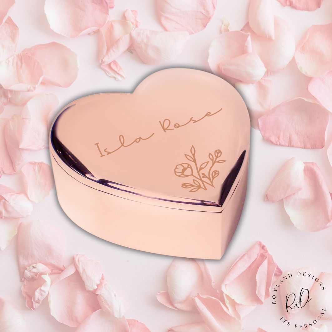 Heart-shaped rose gold compact with 'Isla Rose' branding on pink floral background