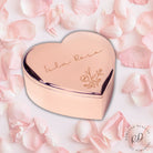 Heart-shaped rose gold compact with 'Isla Rose' branding on pink floral background