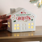 Detail of the personalized name and 'believes' engraving on the ceramic light-up house.