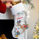Detail of the festive reindeer motif on the front of the personalised velvet stocking.
