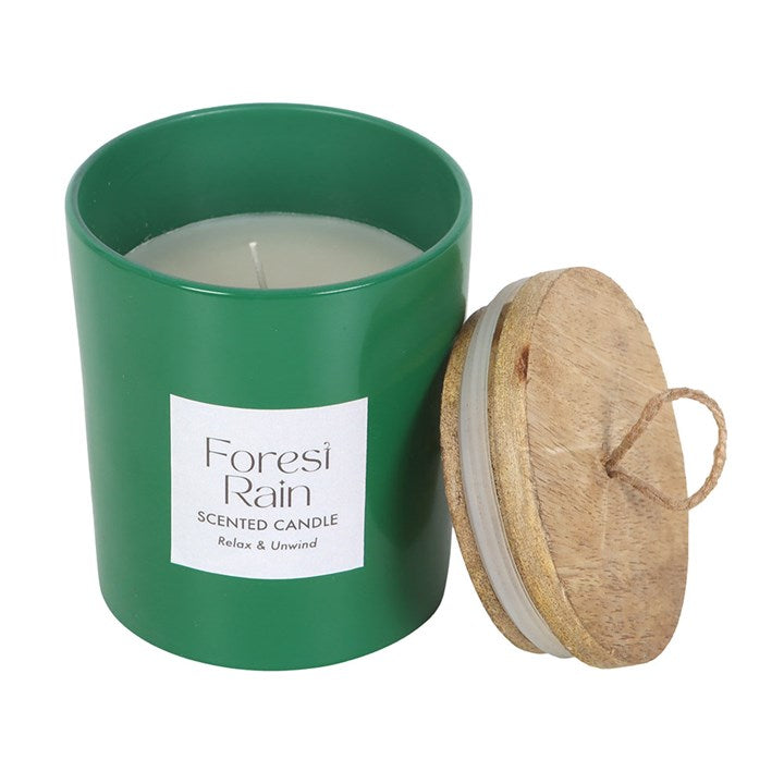 Green scented candle with wooden lid on a white background
