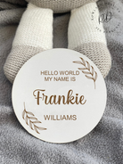 White MDF baby arrival sign featuring a minimalist leaf design and custom name.