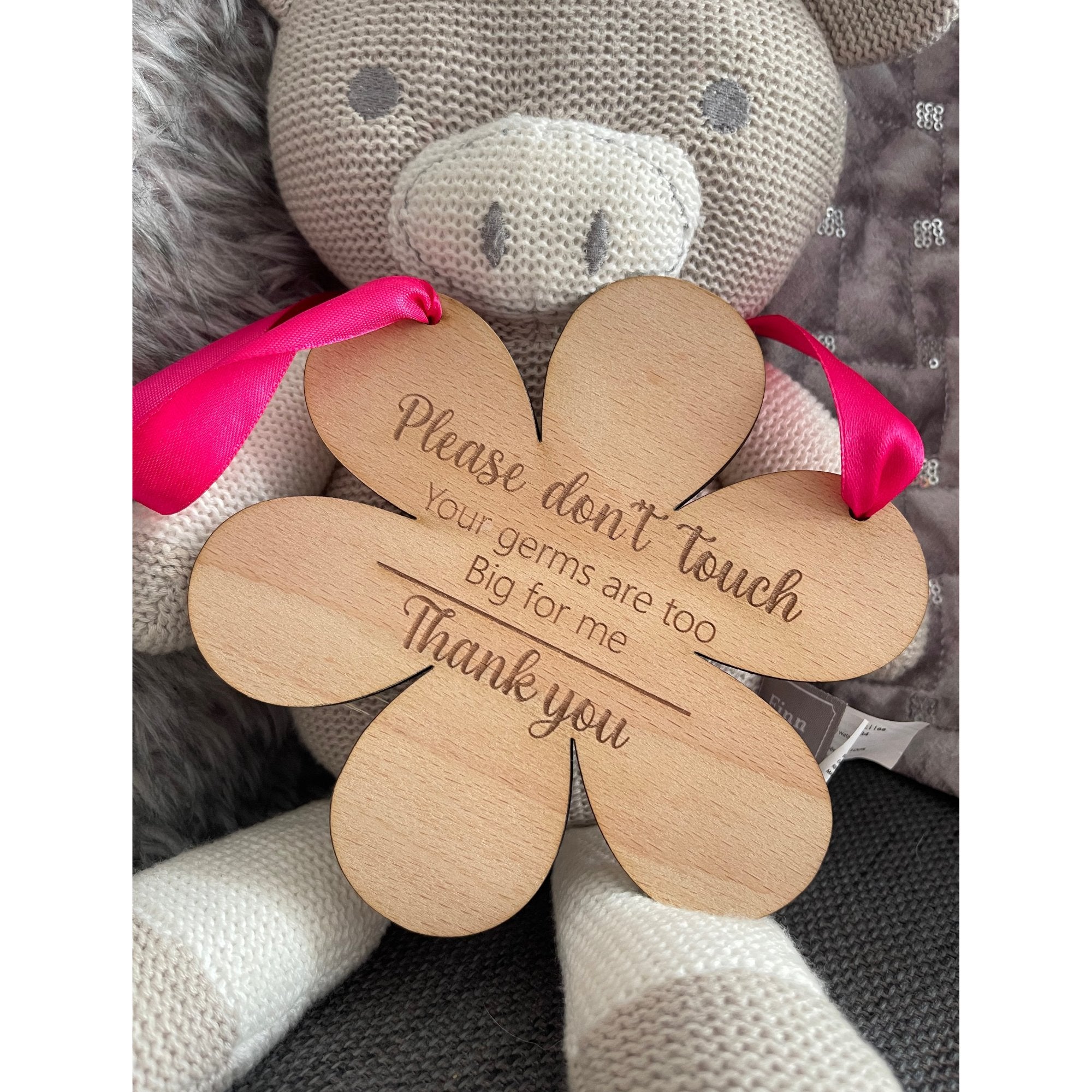 Natural beech wood pram sign with safety message and soft blue ribbon – perfect for newborn outings.

