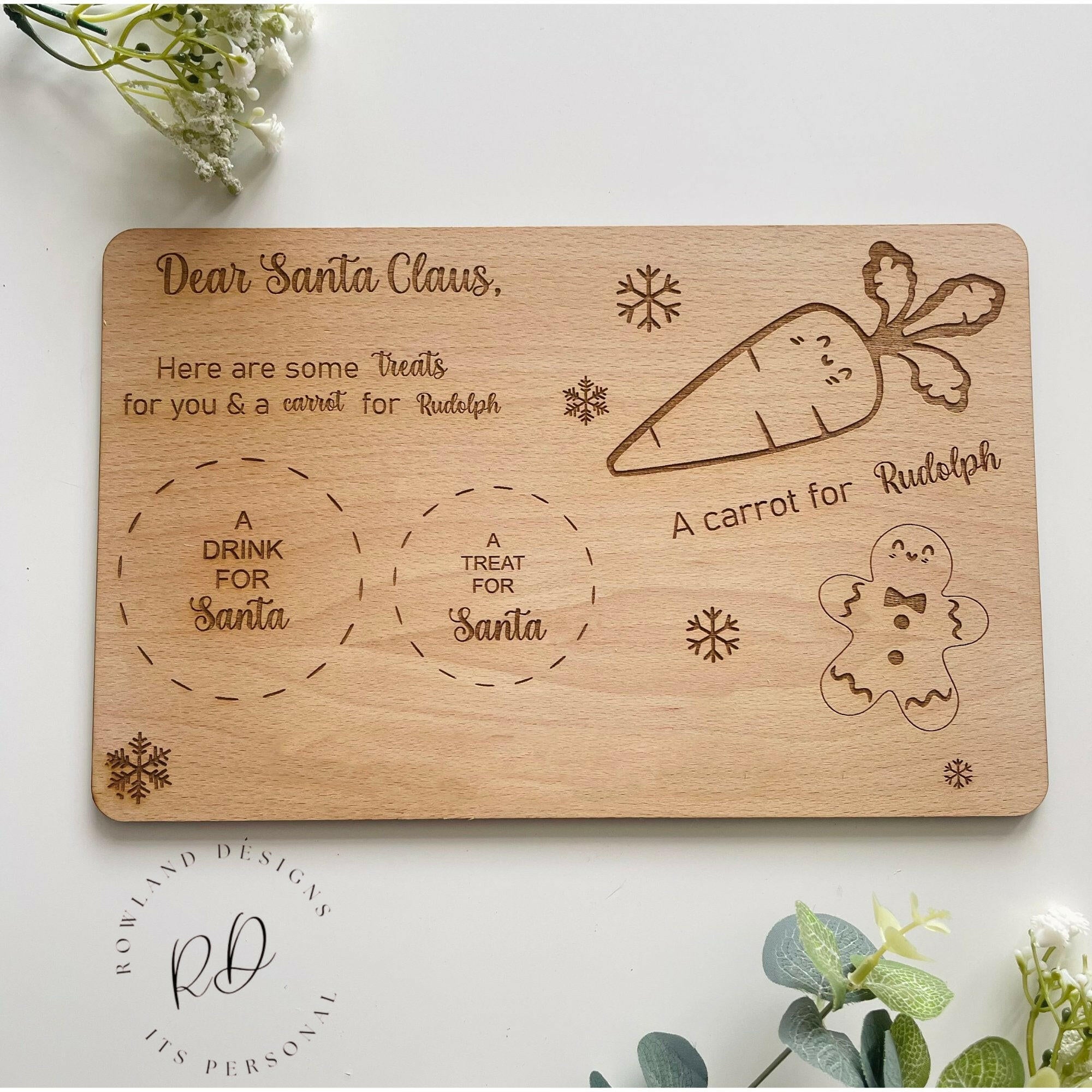 A wooden Christmas Eve board with spaces for Santa's treats and Rudolf's carrot.