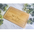 A personalised chopping board with a heart design placed on a kitchen counter, showcasing it as a stylish kitchen accessory.