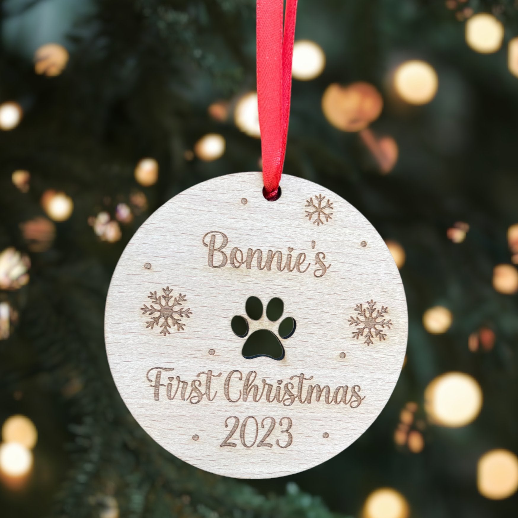 A wooden "Dog's First Christmas" ornament, custom engraved with the pet's name.