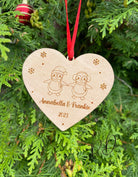 An engraved wooden Christmas gift for a couple, showing their names and the year.
