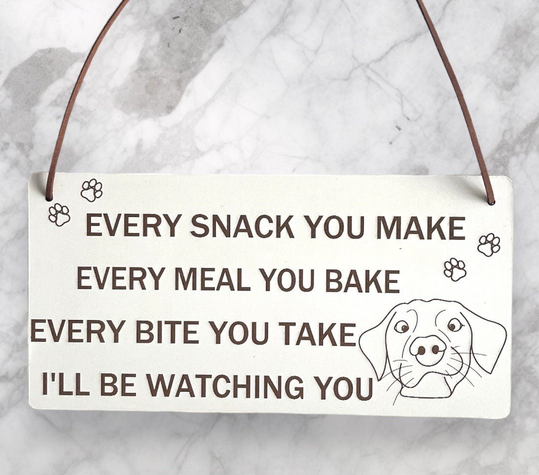 Plaque Size: 220 x 110 mm (approx) Thickness: 3mm Text reads: Every snack you make every meal you bake every bite you take i'll be watching you Suitable For: Dog Signs For Home, Gifts For Dog Lovers, Dog Signs And Plaques, Funny Dog Sign, Birthday Gift Style: Contemporary Material: White coated MDF with brown faux leather hanger Indoor use only Made in England
