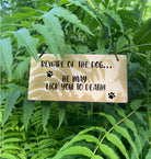 A funny "Beware of the Dog - He May Lick You to Death" sign in a gold finish.