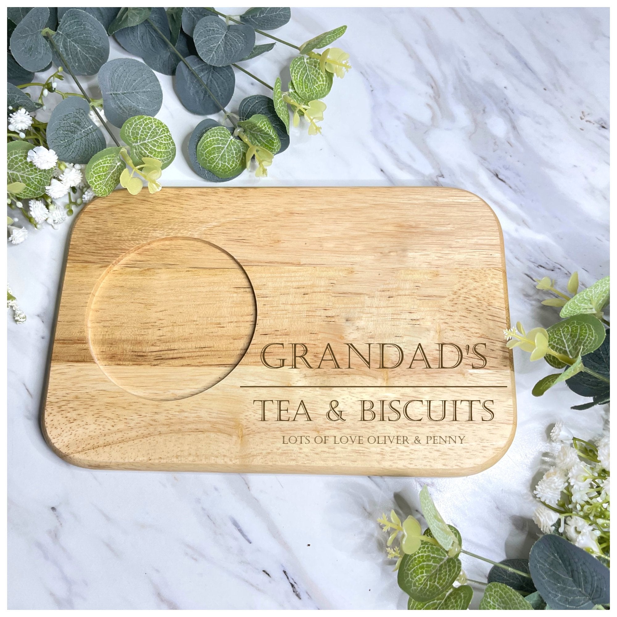 Close-up of a wooden tea and biscuit board with a custom engraved message, showcasing a secure cup slot and elegant design, perfect for birthdays, anniversaries, or festive gifts.