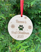 Personalised dog Christmas decoration hanging on a Christmas tree with red ribbon