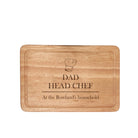 Engraved wooden chopping board with 'DAD HEAD CHEF' text and a chef's hat illustration.