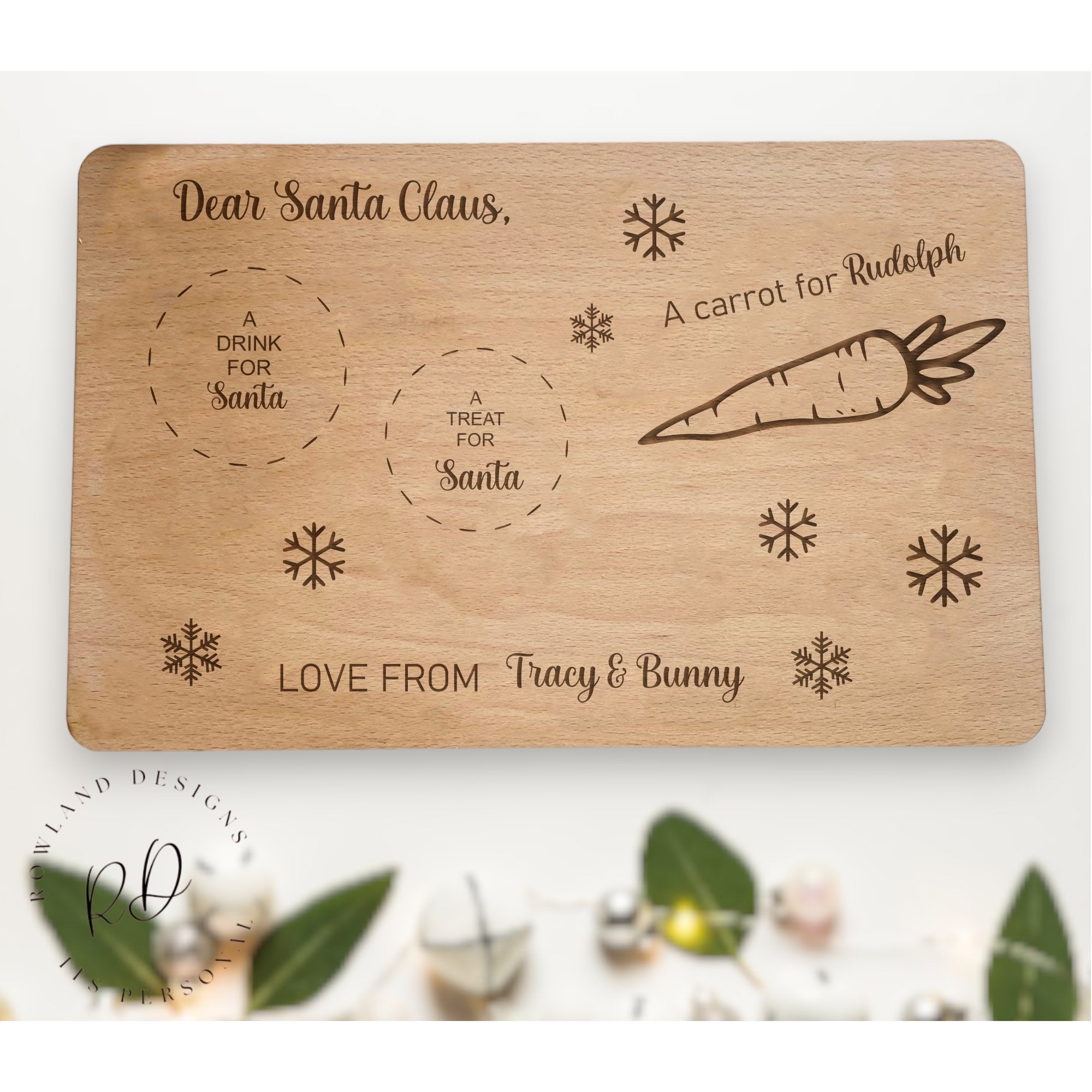 Rectangular personalised wooden Christmas Eve Board with spaces for treats and the names of up to three children engraved at the bottom.

