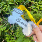 A bone-shaped pet remembrance keepsake made from durable acrylic.